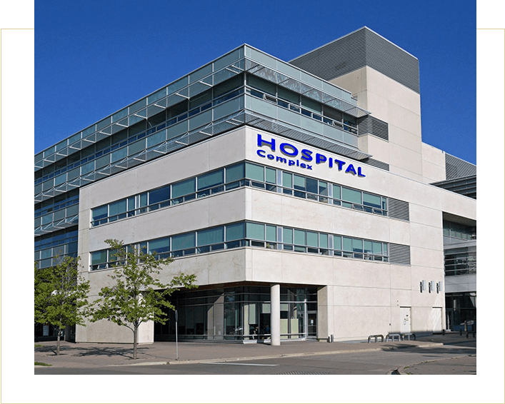 A large hospital building with windows and signage.