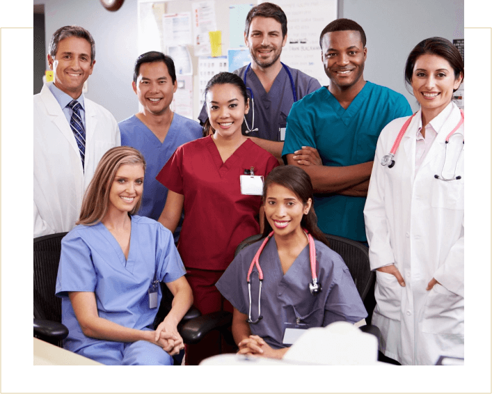 A group of doctors and nurses posing for the camera.