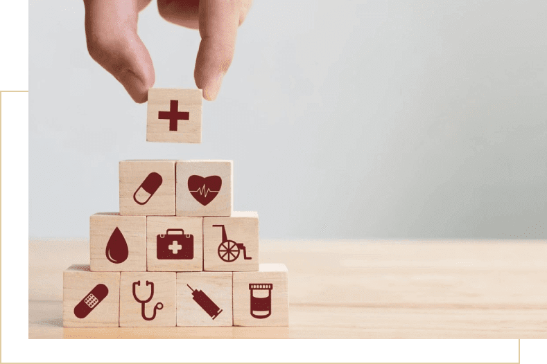 A hand is holding onto blocks with medical symbols on them.